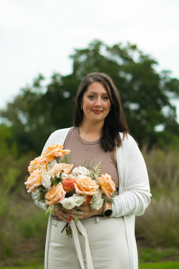 St. Louis Wedding florist, Dawn Gross, holds bridal bouquet