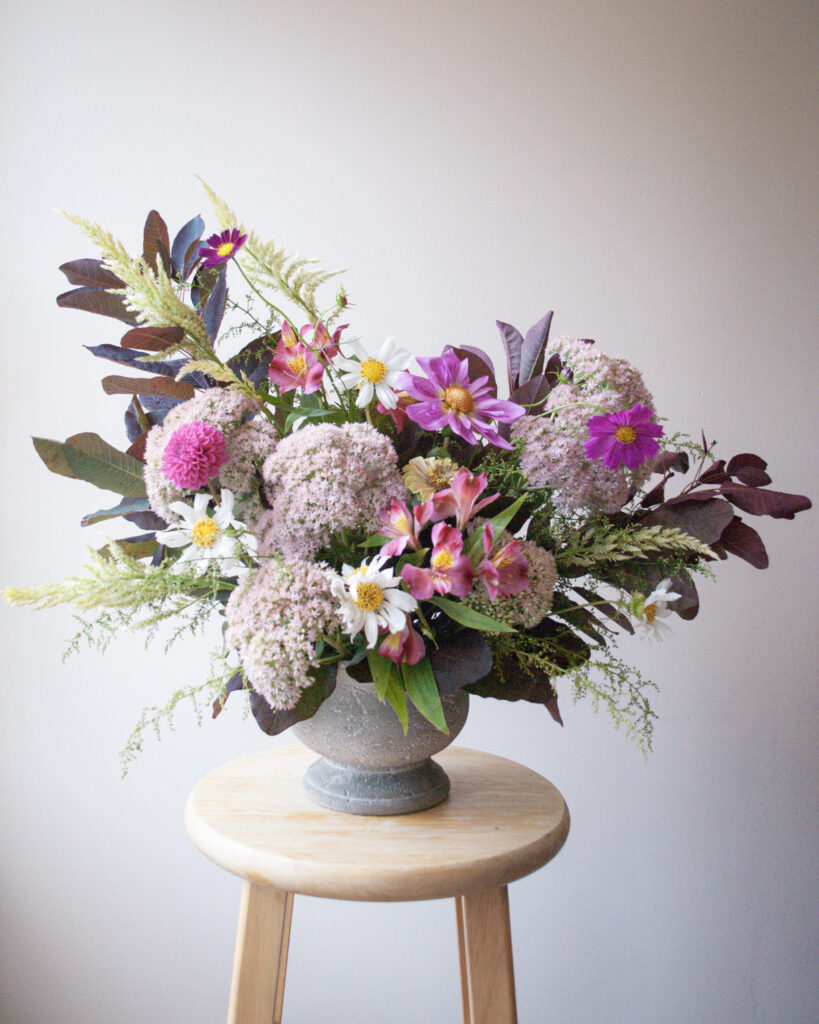 Centerpiece featuring earthy greens and vibrant flowers in St. Louis, Missouri